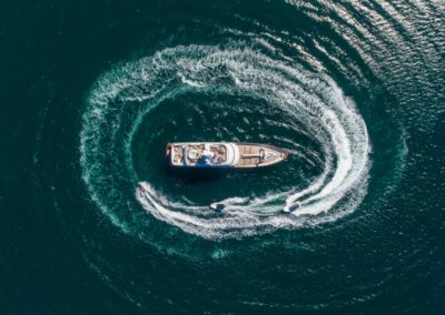 Aerial view of luxury yacht and blue sea at bright sunny day