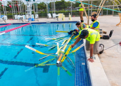 men at the edge of a pool working on XYLEM