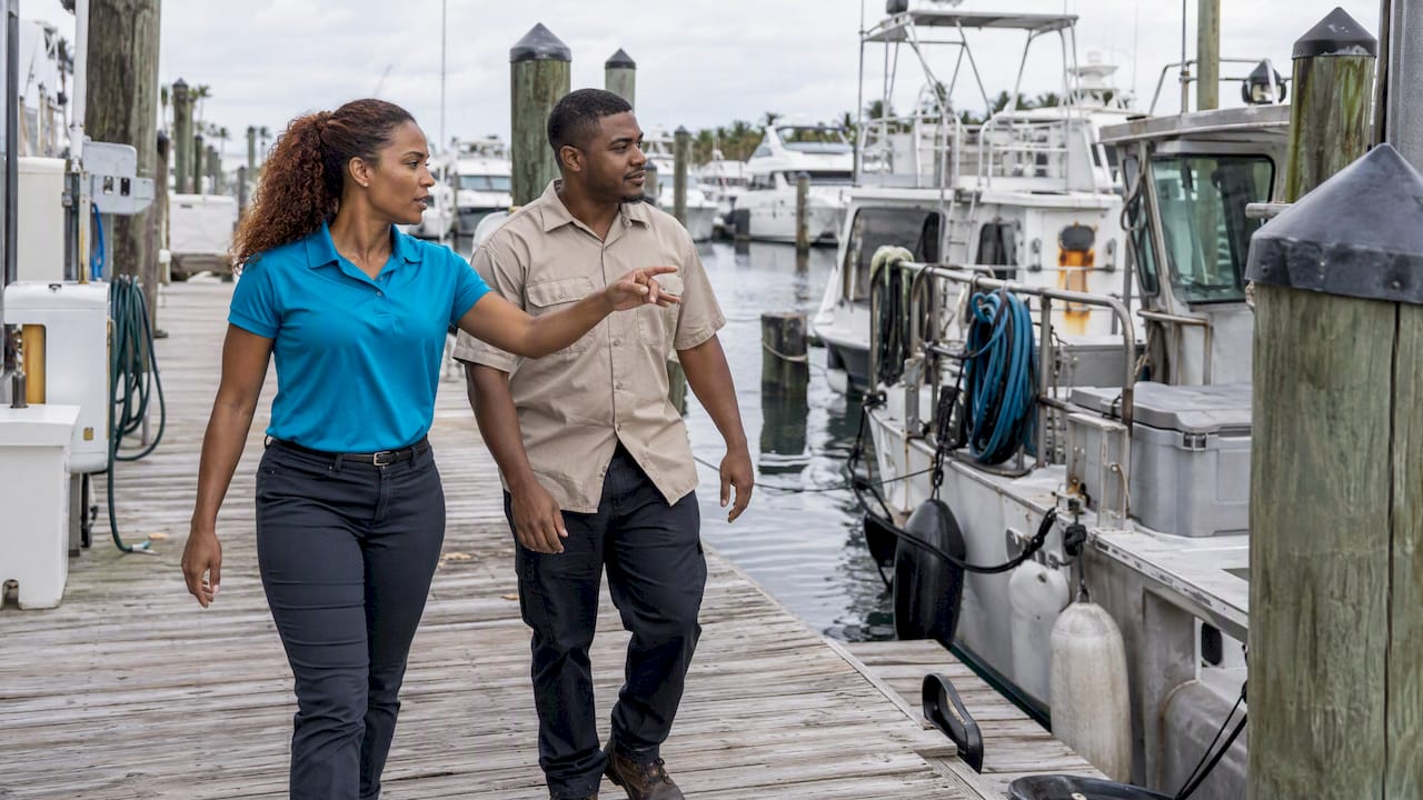 Employee showing a candidate around a marina